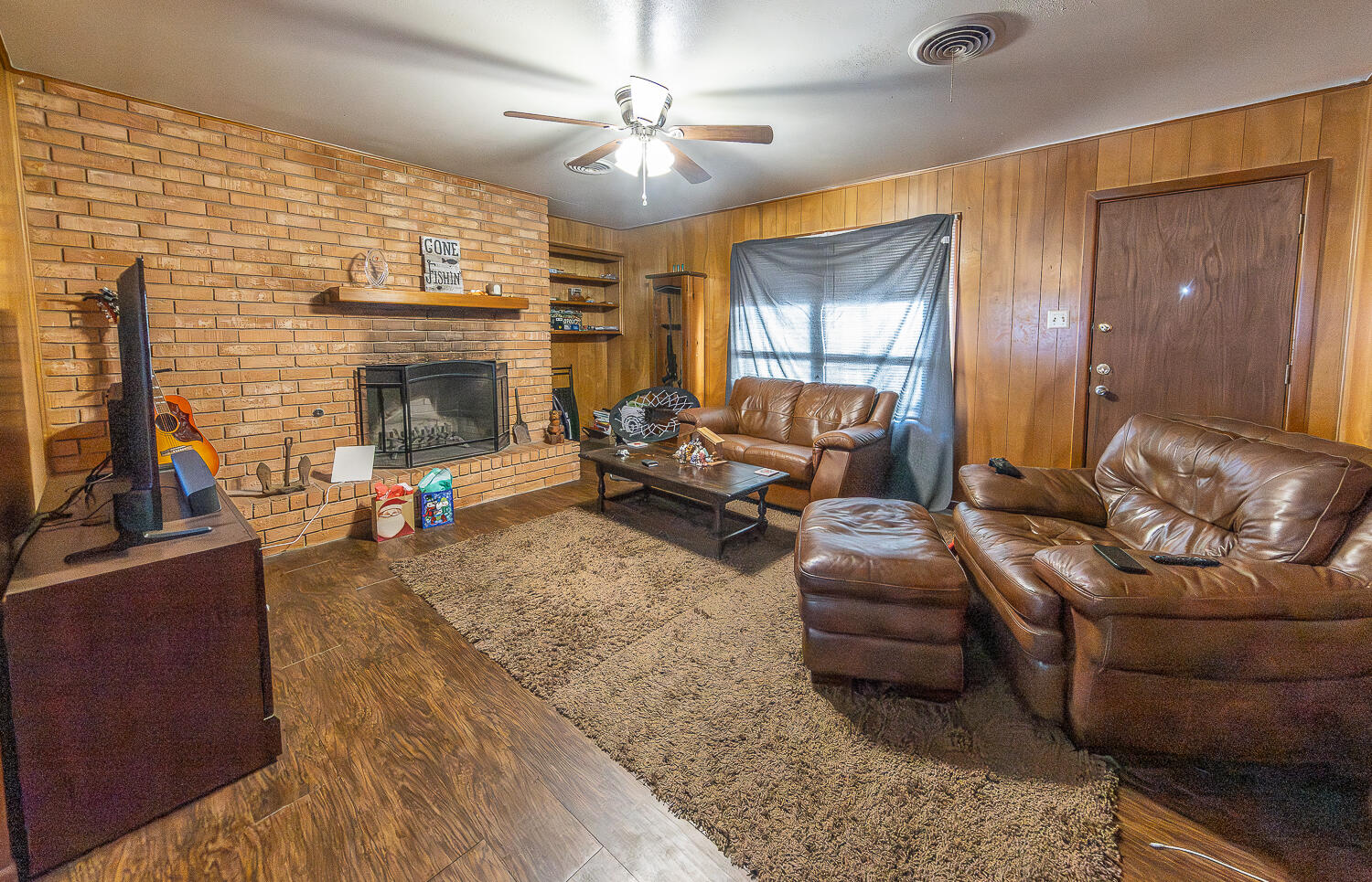 2408 33rd Street Lubbock, TX 79411 - Photo 27 of 31 a living room with furniture and a fireplace