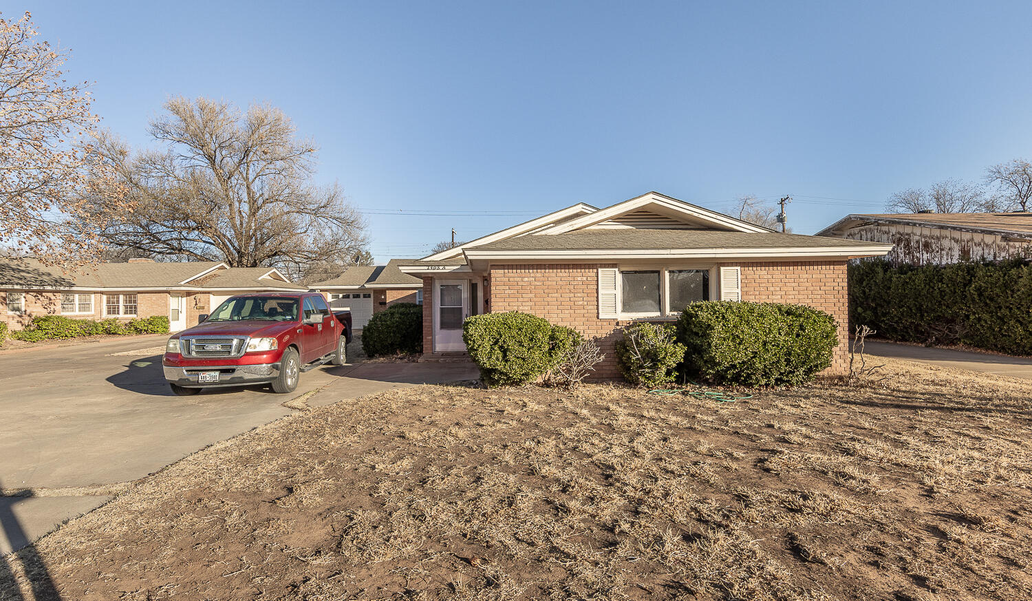 2408 33rd Street Lubbock, TX 79411 - Photo 31 of 31 a front view of a house with a yard