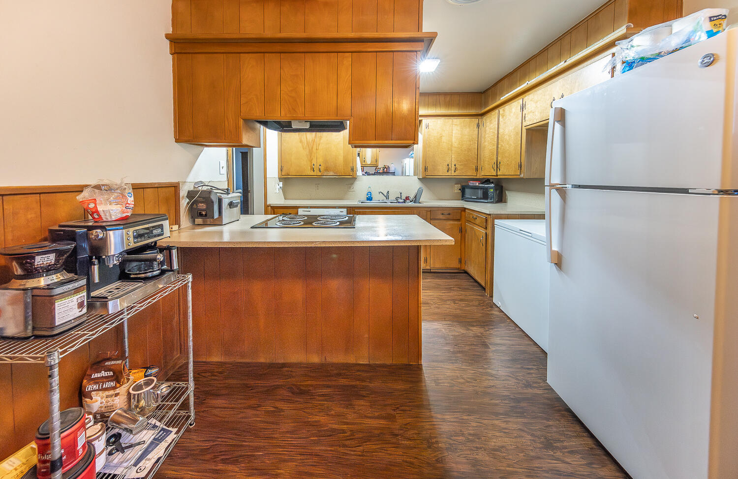 2408 33rd Street Lubbock, TX 79411 - Photo 6 of 31 a kitchen with stainless steel appliances granite countertop a refrigerator a stove and a wooden floors