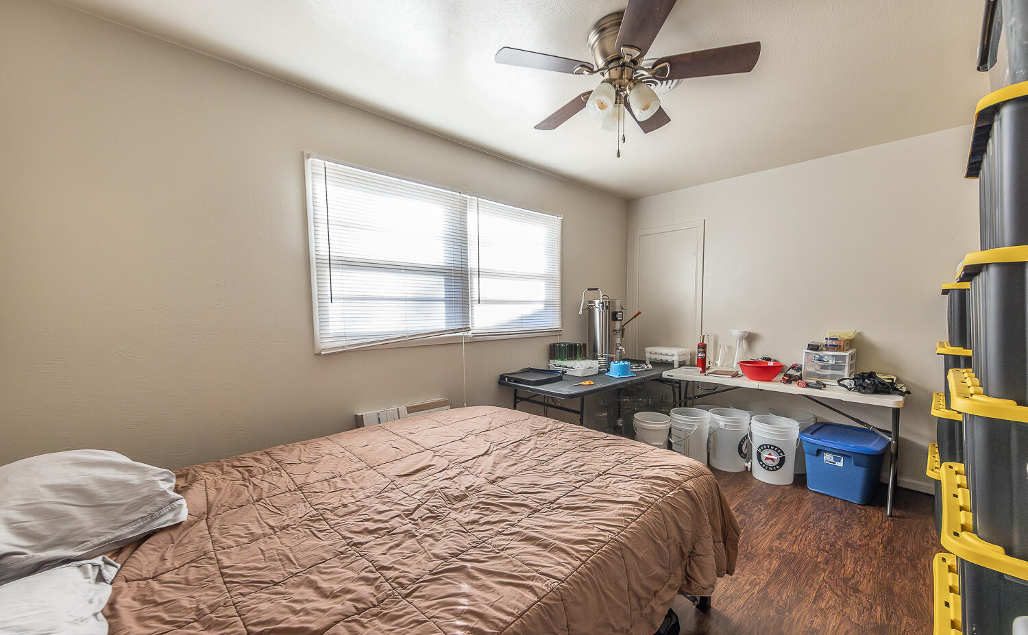 2408 33rd Street Lubbock, TX 79411 - Photo 9 of 31 a bedroom with a bed and a chandelier