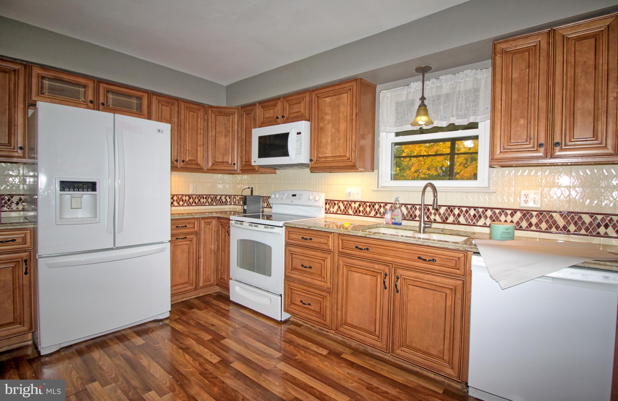 5108 New Kent Road Wilmington, DE 19808 - Photo 12 of 26 a kitchen with a refrigerator sink and cabinets