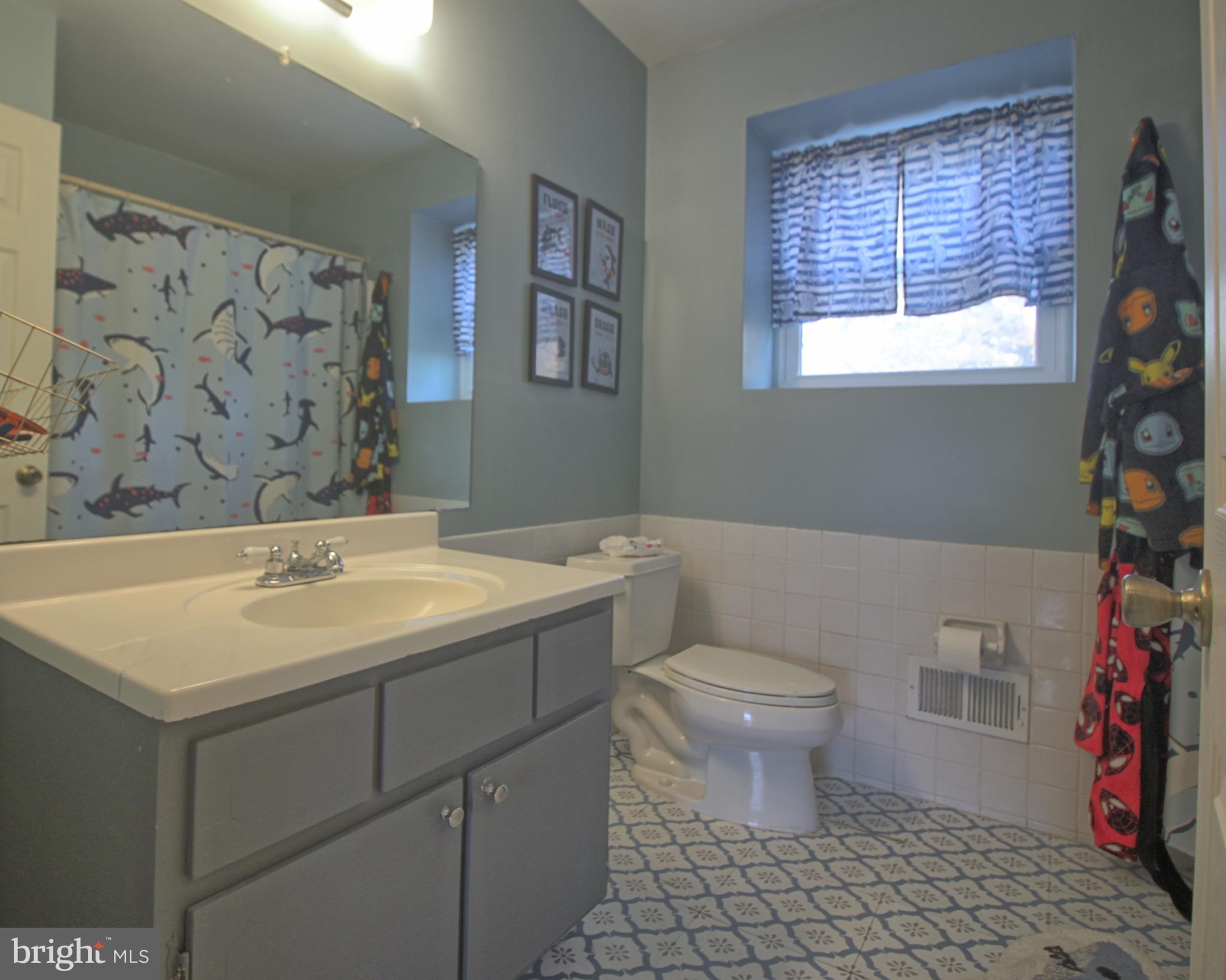 5108 New Kent Road Wilmington, DE 19808 - Photo 21 of 26 a bathroom with a sink a toilet and a window
