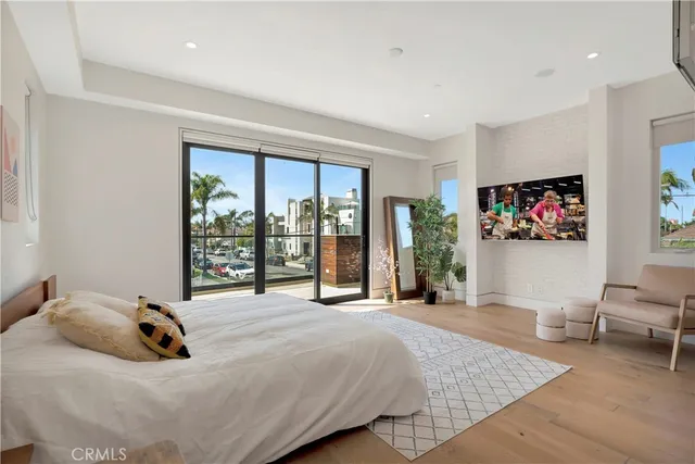 a bedroom with a large bed and a chandelier