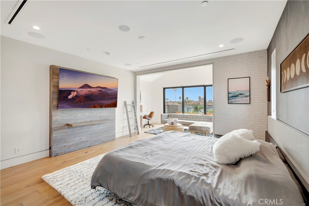 620 Huntington Street Huntington Beach, CA 92648 - Photo 35 of 65 a bedroom with a bed and wooden floor