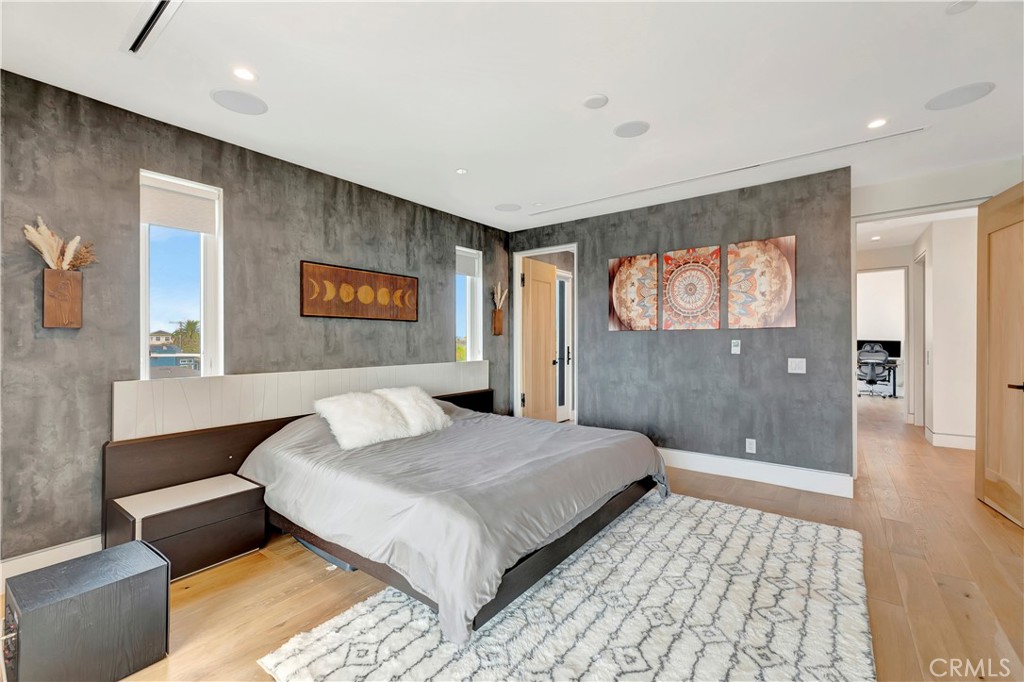 620 Huntington Street Huntington Beach, CA 92648 - Photo 36 of 65 a bedroom with a large bed and a chandelier