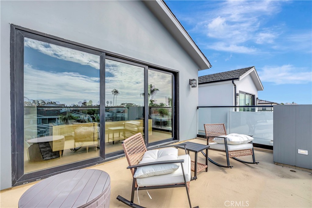 620 Huntington Street Huntington Beach, CA 92648 - Photo 41 of 65 a balcony with chairs and a table