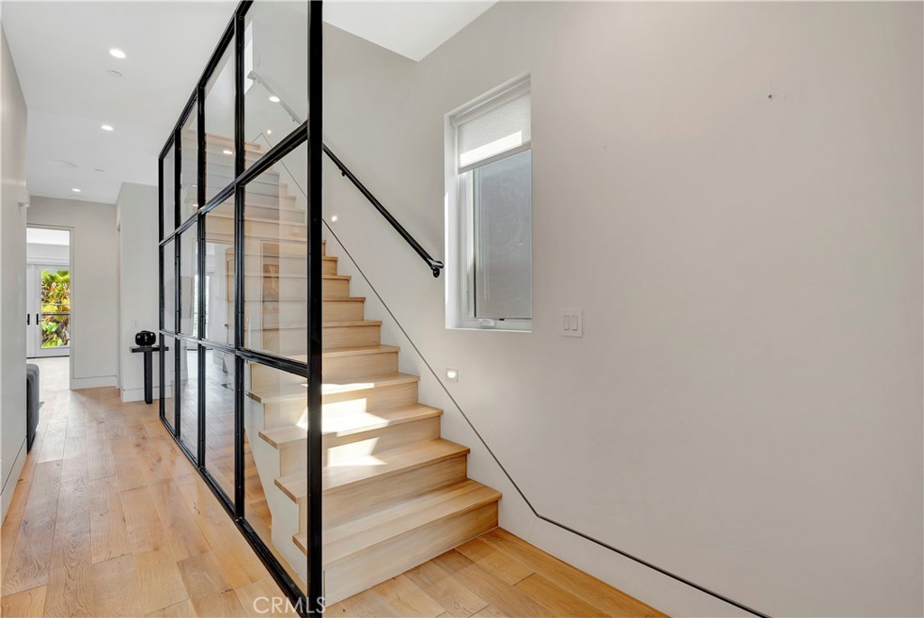 620 Huntington Street Huntington Beach, CA 92648 - Photo 52 of 65 a view of staircase with lots of frames on wall and wooden floor