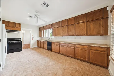 a kitchen with granite countertop a refrigerator and a sink