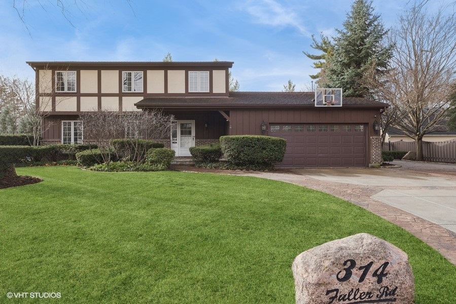 314 Fuller Road Hinsdale, IL 60521 - Photo 1 of 21 a front view of a house with a garden and plants