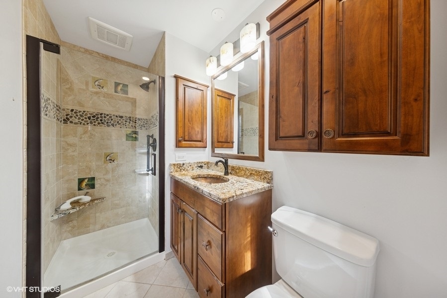 314 Fuller Road Hinsdale, IL 60521 - Photo 11 of 21 a bathroom with a granite countertop sink toilet and shower
