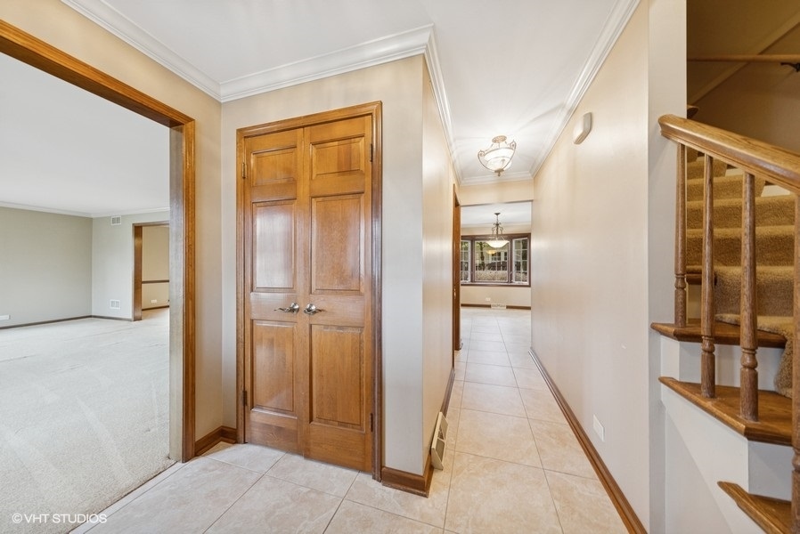 314 Fuller Road Hinsdale, IL 60521 - Photo 2 of 21 a view of a hallway with wooden floor and staircase