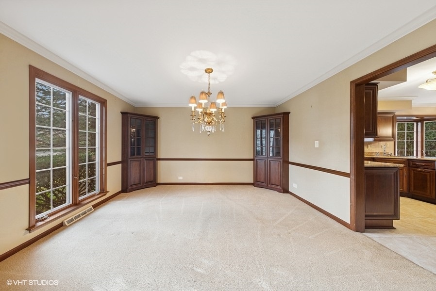 314 Fuller Road Hinsdale, IL 60521 - Photo 4 of 21 an empty room with chandelier fan and windows