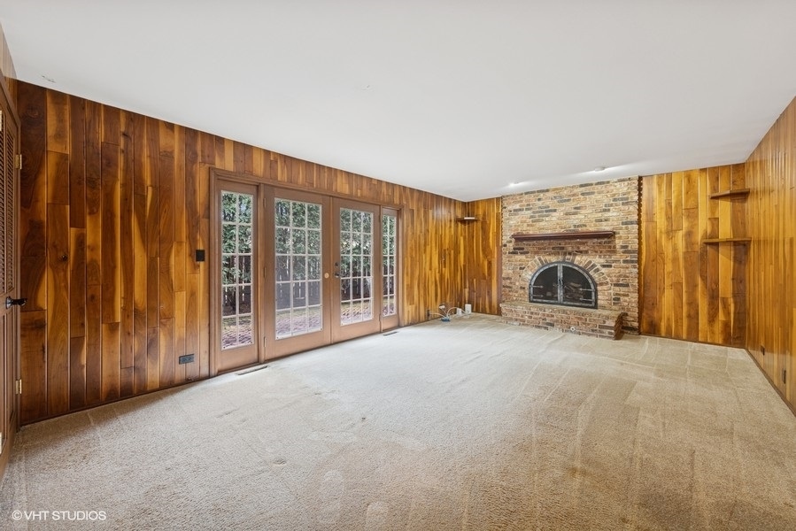 314 Fuller Road Hinsdale, IL 60521 - Photo 8 of 21 a view of an empty room with a fireplace and a window