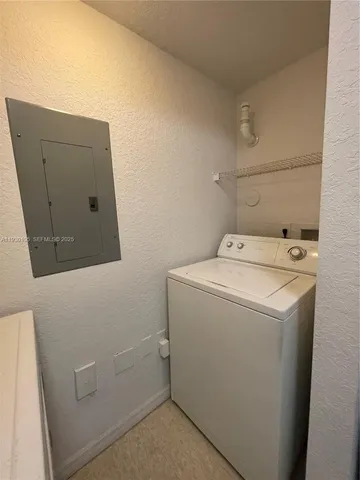 a view of a livingroom with a ceiling fan & entryway