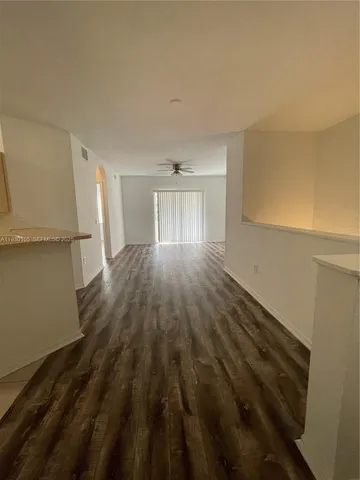 a view of an empty room with a floor to ceiling window