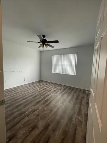 a view of a livingroom with wooden floor and staircase