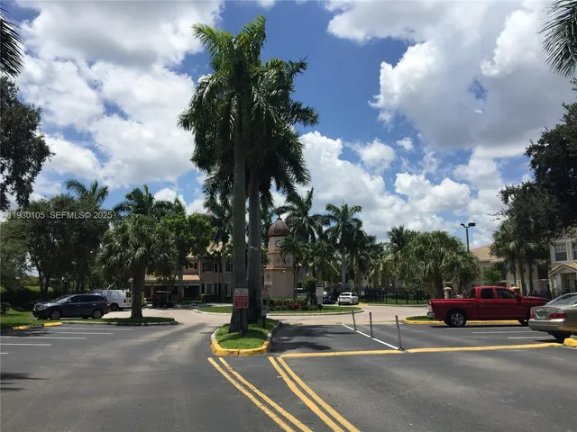a view of a street with a cars park