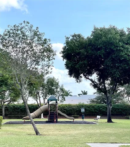 an aerial view of a house with a yard and lake view in back
