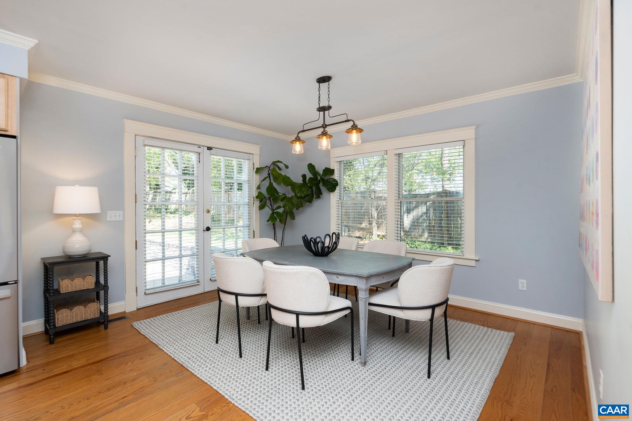 417 9th Street Northwest Charlottesville, VA 22903 - Photo 12 of 33 a dining room with furniture window and wooden floor