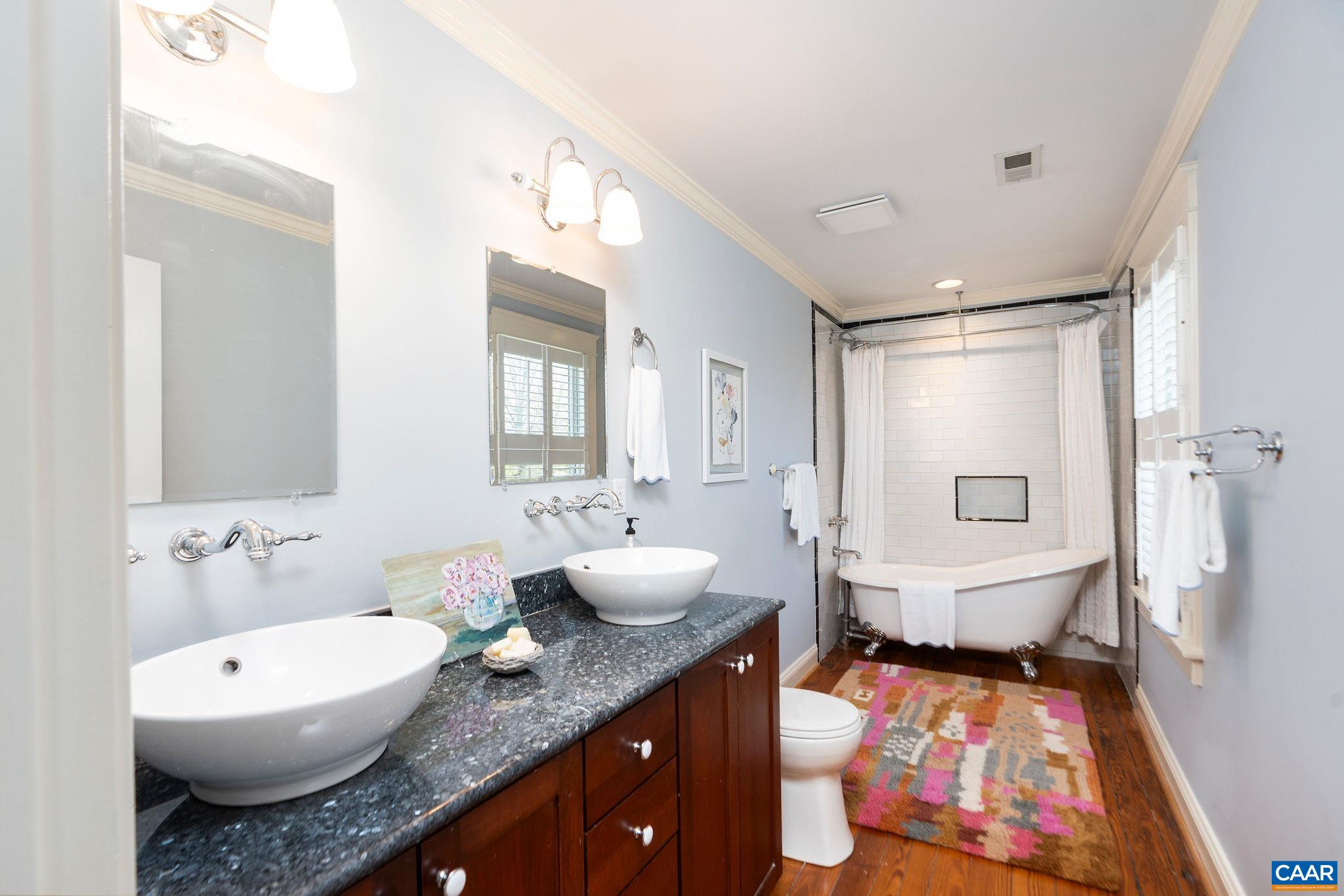 417 9th Street Northwest Charlottesville, VA 22903 - Photo 18 of 33 a spacious bathroom with a granite countertop sink mirror vanity and toilet