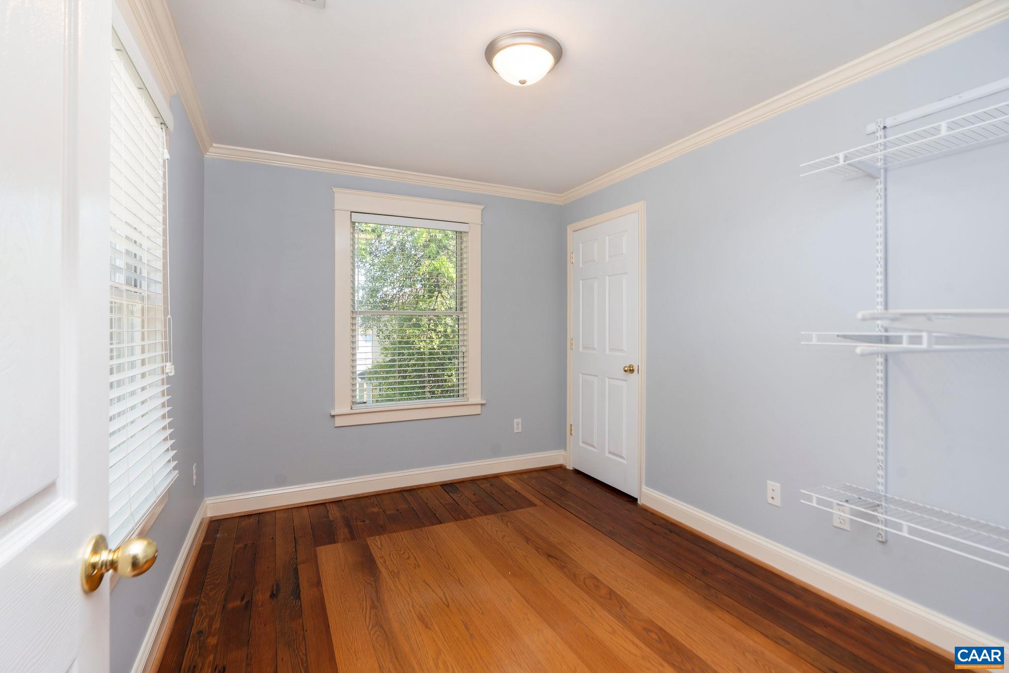 417 9th Street Northwest Charlottesville, VA 22903 - Photo 21 of 33 a view of an empty room with wooden floor and a window