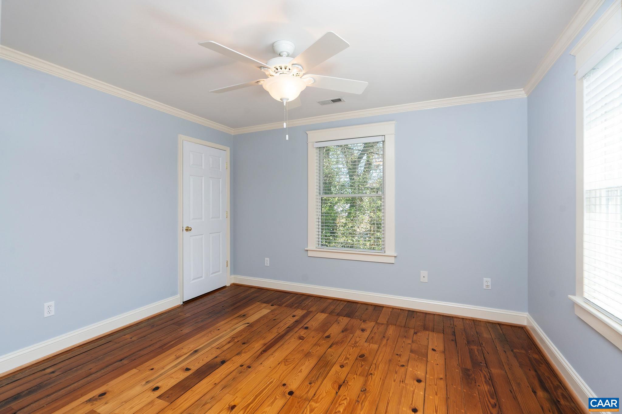 417 9th Street Northwest Charlottesville, VA 22903 - Photo 23 of 33 an empty room with wooden floor and windows