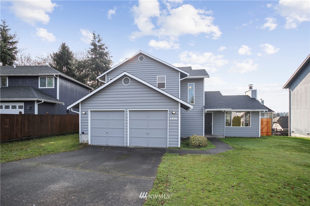 1216 223rd Street Southwest Bothell, WA 98021 - Photo 1 of 22 a front view of a house with a garden