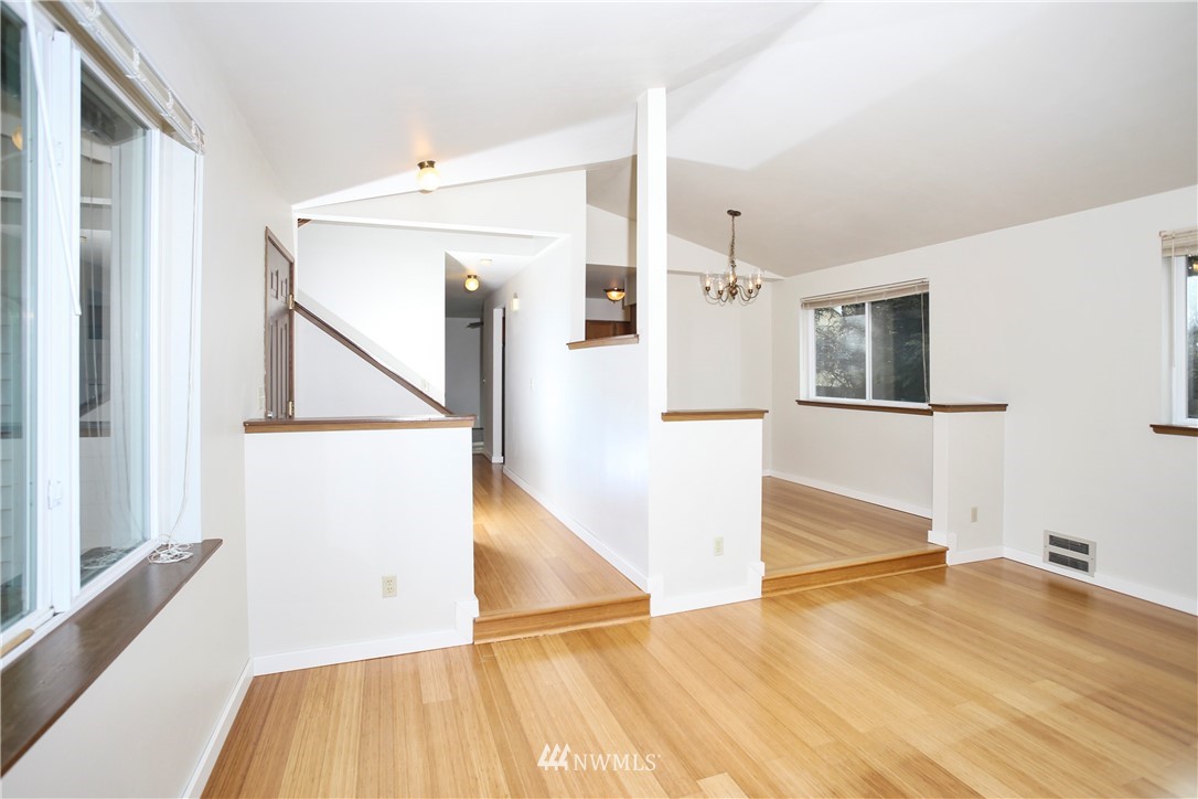 1216 223rd Street Southwest Bothell, WA 98021 - Photo 3 of 22 a view of a hallway with wooden floor and staircase