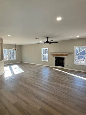 an empty room with wooden floor and fireplace