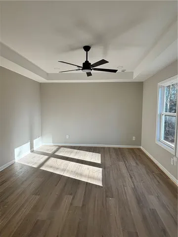 a view of a room with wooden floor and a window