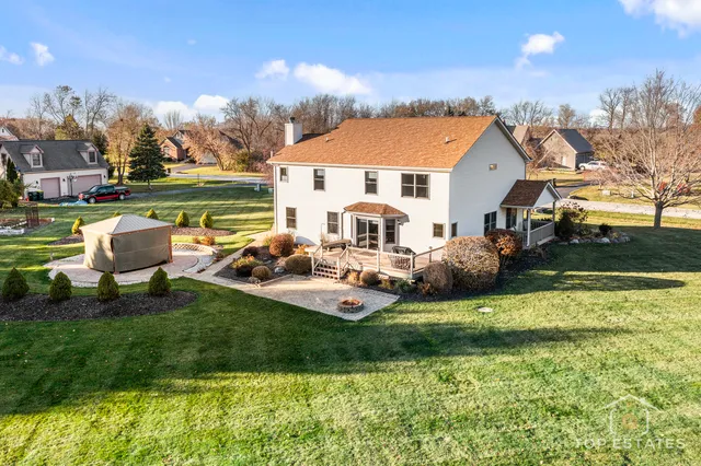 a view of a house with backyard and sitting area