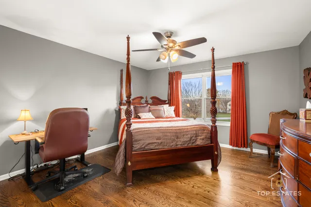 a bedroom with a bed a chair and a chandelier