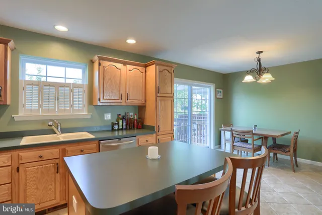a kitchen with a dining table chairs and granite counter tops