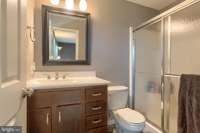 a bathroom with a toilet a sink and a mirror