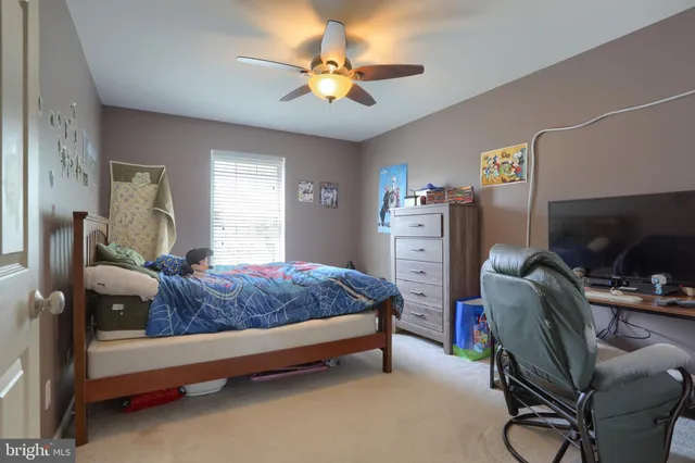 a bedroom with a bed gym equipment and a chandelier