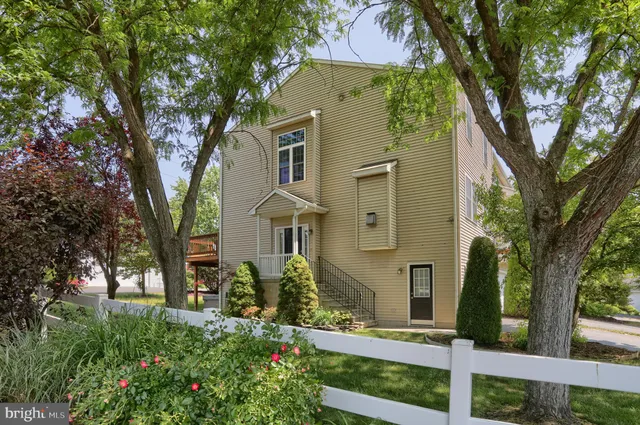 front view of a house with a tree in the background