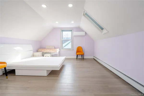 a view of a bedroom with a couch and a ceiling fan
