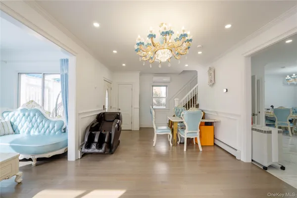 a living room with furniture and a chandelier