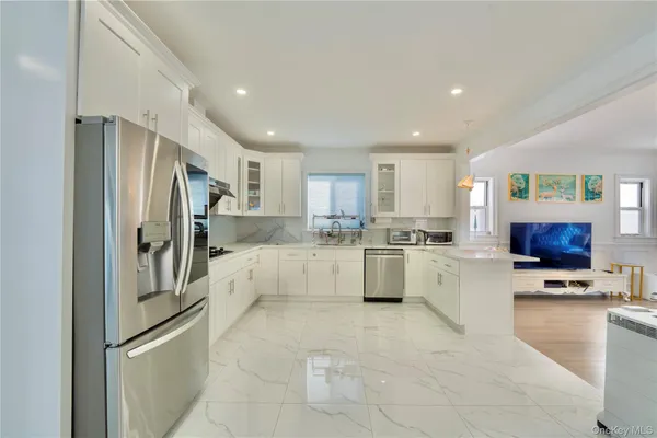 a kitchen with a refrigerator and a sink