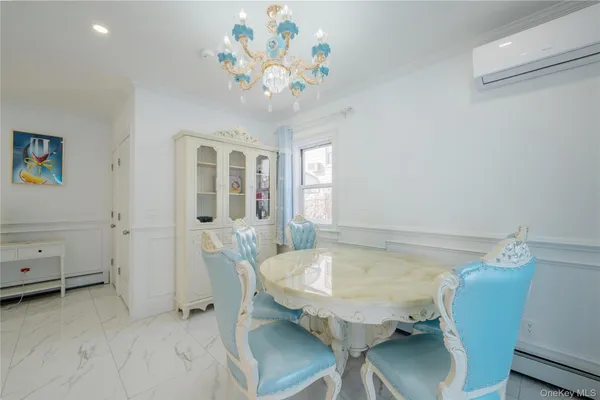 a view of a dining room with furniture and chandelier