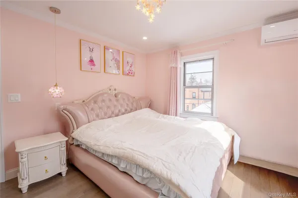 a bedroom with a large bed and a chandelier