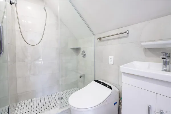 a bathroom with a sink a toilet and a shower