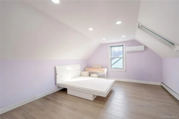 a spacious bedroom with a bed and a window