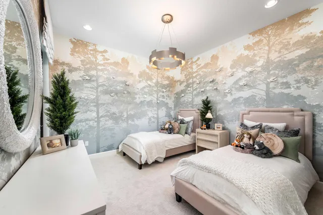 a spacious bedroom with two beds and potted plant