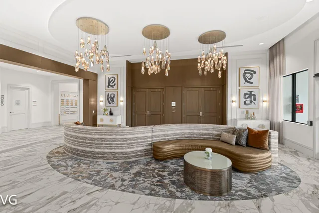 a living room with furniture and a chandelier