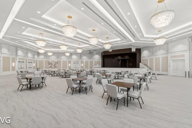 a view of a dining room with furniture a chandelier and wooden floor