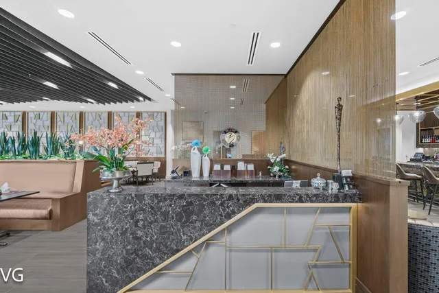 a living room with lots of furniture and a potted plant