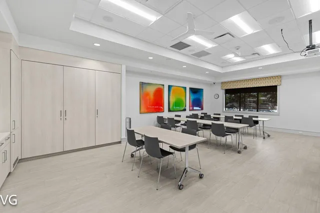 a large kitchen with kitchen island a sink stainless steel appliances and cabinets