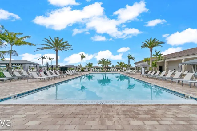 a view of a swimming pool and lounge chairs