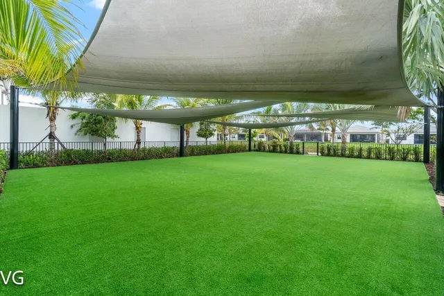 an aerial view of a house with outdoor space and lake view